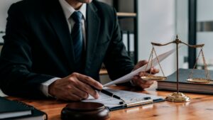 Personal injury attorney reviewing legal documents at a desk.