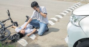 Bicycle helmet on road near injured rider symbolizing Moses Lake bicycle injury claim