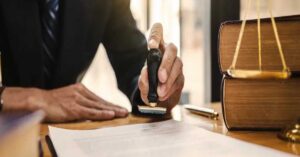 Attorney stamping legal document with law books and scales for Moses Lake wrongful death claim