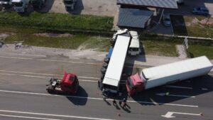 Overturned semi-trucks blocking a highway after a major crash.