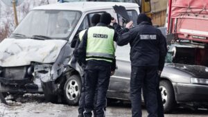 Police officers investigating a truck and van crash at the scene in Seattle