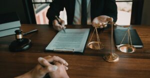 Attorney reviewing documents with scales of justice symbolizing immigration delay lawyers in Wenatchee