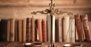 Justice scale in front of law books representing Wenatchee lawyers for immigrants