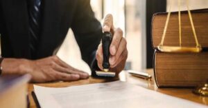 Sexual abuse lawyer reviewing and stamping legal documents in Wenatchee